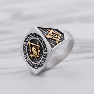 Detail of Masonic titanium steel ring with gold relief and Latin engraving on marble