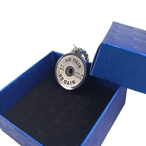 Barbell weight plate necklace in a blue gift box with motivational slogan engraving