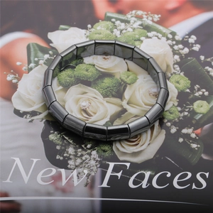Vue détaillée d'un bracelet en hématite gris foncé poli sur le fond d'un magazine