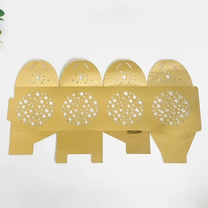 Flat lay of laser-cut gold star gift box with mirror finish and intricate hollow details
