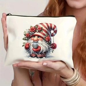 Close-up of cute Christmas gnome printed canvas makeup bag held in hand for scale