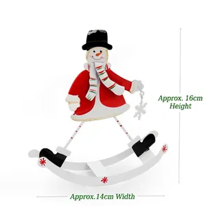 Detail view of a rocking metal snowman figurine with red hat and green scarf for Xmas