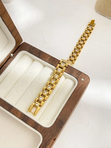 Detail of 18K gold plated watchband link bracelet featuring sparkling white zircon stones