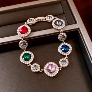 Macro detail of multicolored gemstone bracelet with pavé rhinestones in rose gold base
