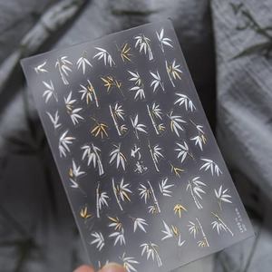 Macro shot of TO 5341 metallic bamboo leaf nail art stickers in gold and white