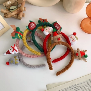 Collection of plush Christmas headbands with reindeer antlers and Santa designs