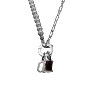 Mixed faux pearl and link chain necklace with Gothic letter Q and red stone pendant.