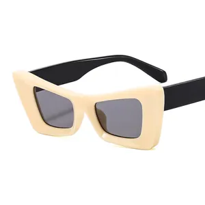 Occhiali da sole retrò cat-eye con montatura crema e aste nere in stile geometrico moderno