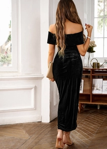 Elegant off-shoulder black velvet long dress showing back draping and sleek fabric texture