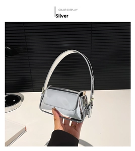 Close-up of a silver mini baguette bag with shiny metallic finish and elegant handle