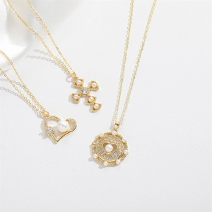 Gold layering necklace set with heart, cross pendants, pearls and zircon on white background