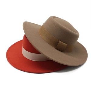 Close-up of wide brim wool felt flat top hats in coffee and red with satin ribbon band
