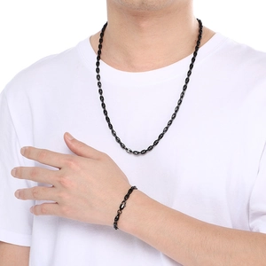 Detail of a black stainless steel coffee bean chain necklace and bracelet set for men