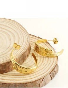 Detail showing 18k gold plated geometric earrings with lead-free and nickel-free texture