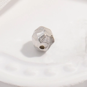 Detailed macro view of S925 sterling silver geometric faceted spacer beads for jewelry DIY