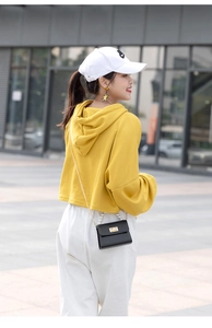Close-up of a yellow jelly bag with crocodile pattern and pearl chain strap details