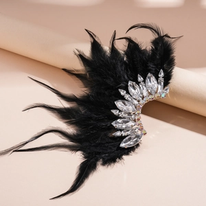 Macro shot of elegant black feathers and sparkling crystals on bohemian wrap earring