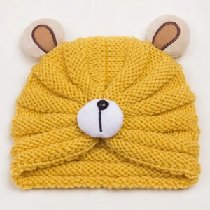 Detailed knit texture of a yellow baby bear ear hat with cute plush nose detail