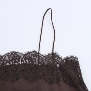 Detail shot of the delicate lace trim and pleated satin fabric on the brown camisole top