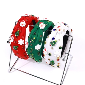 Detailed view of Christmas headbands with Santa, tree, and snowflake rhinestone ornaments