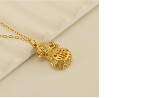 Detailed view of 18k gold plated lucky bag pendant necklace with sparkling rhinestones