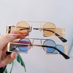 Steampunk sunglasses with geometric gold frames and dual-color lenses in blue and orange