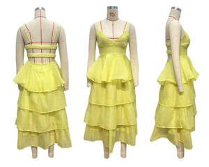 Detail of yellow backless tiered chiffon dress with cross straps and V-neckline