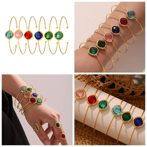 Macro shot of faceted Czech glass open bangles with gold plating in assorted colors