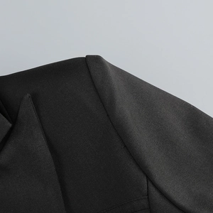 Detail of the high-quality stitching and twill fabric texture on a black blazer dress