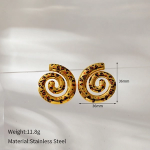 Macro shot of gold-plated stainless steel spiral earrings with leopard pattern