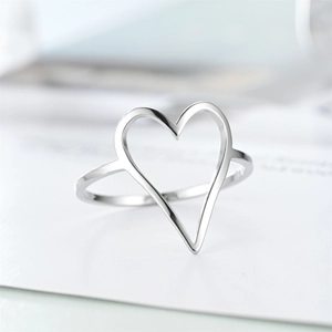 Close-up of minimalist silver stainless steel hollow heart ring with smooth polished finish
