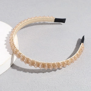 Detail view of handmade champagne crystal beaded headband with luxury fabric wrap