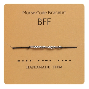 Handmade Morse Code BFF bracelet with silver beads on black cord on kraft display card