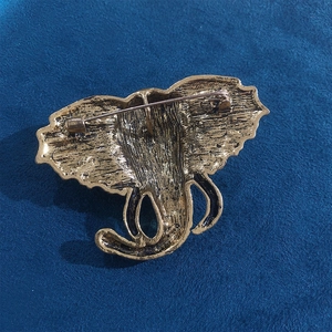Vintage elephant head brooch in gold tone with textured metal back and pin closure