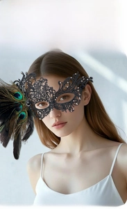 Detailed close-up of a black lace eye mask featuring sparkling rhinestones and real feathers