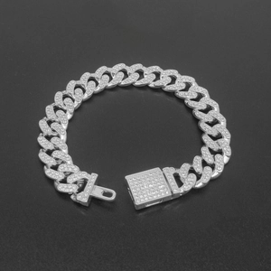 Detailed view of silver iced-out 12mm Cuban link chain with crystal pave box clasp