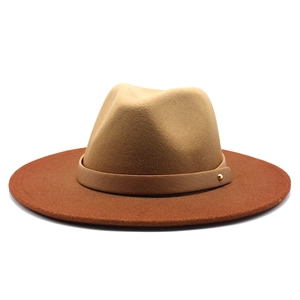 Detail of wool fedora showing khaki crown and rust red brim with leather band