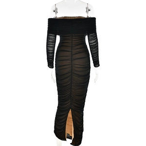 Detail view of the back of a black mesh ruched dress with a back slit on a mannequin