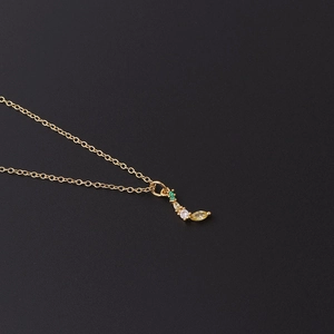 Macro shot of gold crescent pendant featuring colorful marquise-cut zircon stones