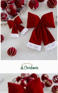 Close-up of red velvet Christmas bow with white plush trim on a festive background