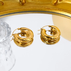 Polished 18K gold-plated C-shaped twist hoop earrings with a reflective finish