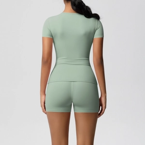 Rear view of mint green high-stretch sports set with slim-fit t-shirt and yoga shorts