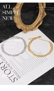 Detail of 18K gold and silver plated copper chain bracelets with lobster clasp and tag
