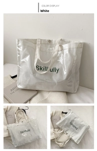 Detailed view of white canvas tote with transparent PVC layer and Skillfully lettering