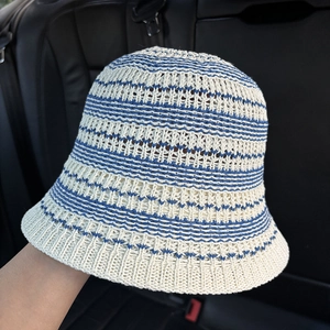 Close-up of the breathable openwork crochet knit and striped pattern on the bucket hat