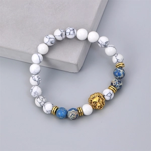 Men's beaded bracelet featuring white turquoise, blue stones and a golden lion head charm