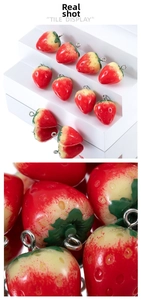 Macro shot of 3D realistic strawberry charms with textured red gradient for DIY jewelry