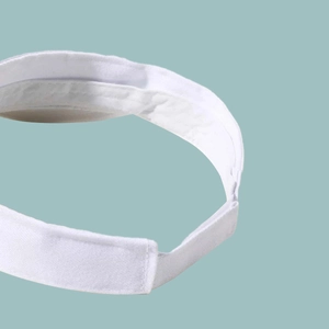 Detail view of the breathable sweatband and adjustable strap of the white sun visor hat
