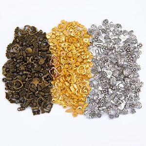 Mixed DIY jewelry charms in bronze, gold, and silver finishes with various unique shapes