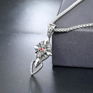 Macro detail of cross pendant with red gemstone and 925 silver stamp on box chain